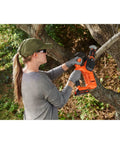 Person trimming a tree branch using 20V Max Pruning Chainsaw Kit With Battery And Charger Included For Cordless Small Branch Cleanup