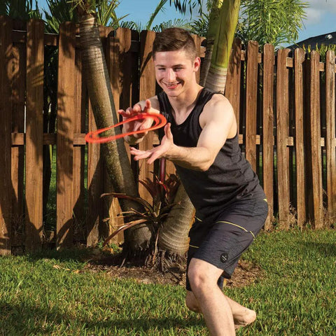 Man throws 10 Inch Sprint Ring Flying Disc for Maximum Distance, Lightweight Outdoor Ring Thrower in backyard