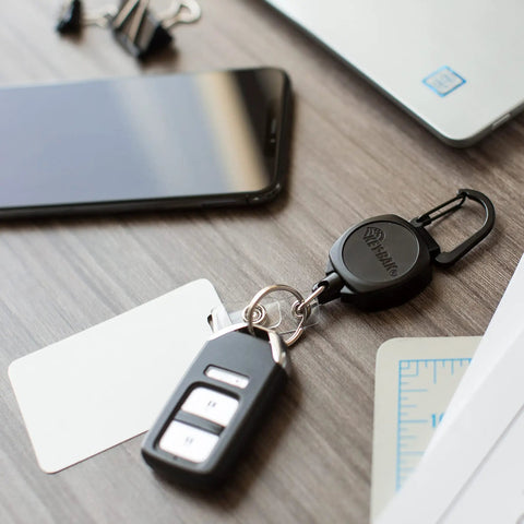 Sidekick ID Badge And Key Reel With 24 Inch Kevlar Cord on desk with key and ID card