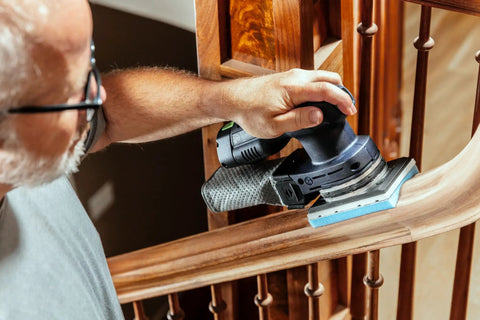 Foam Back Contouring Abrasive Discs With Hook And Loop Mount in use on a wooden railing, Pro Grade Flexible Half Inch Foam Core