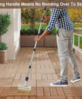 Man using Long Handle Deck Stain Brush Set Pro Grade With 60 Inch Reach staining wood deck in autumn park setting