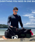 Person with XL Mesh Duffle Dive Bag Packable Roll Up 100L for Scuba Snorkeling Gear on boat by the sea