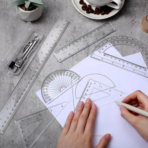 Real Deal 7 Piece Geometry Set With Fine Tip Drawing Compass And 6 Plus 4 Inch Protractors Clear Triangle And Straight Ruler Smooth Drafting Gear For Back To School And Office on a desk.