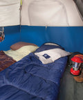 Blue Brazos 20 To 30 Degree Fahrenheit Adult Cool Weather Sleeping Bag With No Snag Zipper And Stuff Sack in a camping tent.