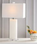 White Alabaster 27 Inch Rectangular Table Lamp With White Linen Shade on table beside vase with flowers