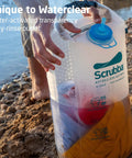 Pocket Sized Portable Travel Wash Bag Featuring Patented Washboard Design Ultra Lightweight Foldable Clothes Cleaner, rinsing clothes by the water.