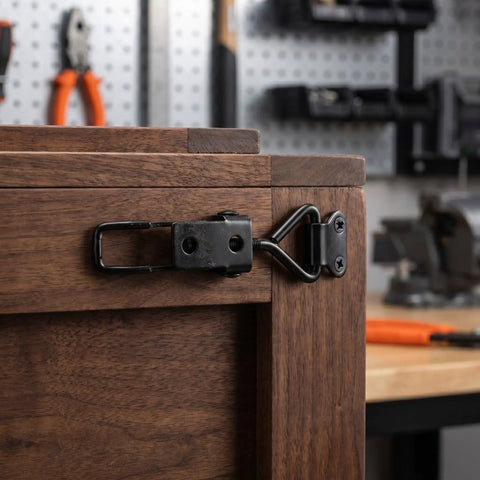 Solid Black Toggle Latch Clamps For Heavy Duty Toolboxes With 220lbs Grip And Vibration Proof Design on wooden toolbox edge.