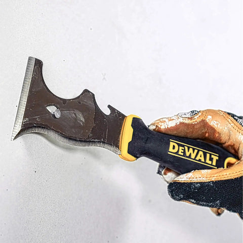 9-In-1 Painter's Tool With Straight And Curved Scrapers, gouger, hammer, held by gloved hand against wall