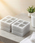 Fifty Pack Disposable Shower Drain Hair Catcher Stickers stacked on a bathroom counter for easy access and use.