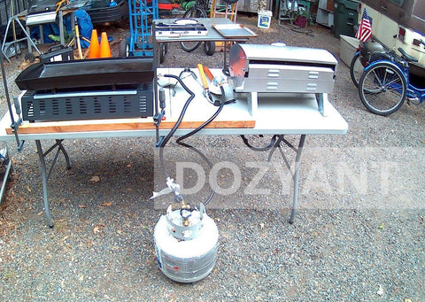 Propane Splitter Adapter With Gauge, 2 Way LP Gas Tee Connector For 20lb Tanks connected to grills on a table outdoors
