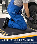 Mechanic using Heavy-Duty Anti-Fatigue Standing Mat 39 By 20 Inches With Safety Yellow Border in garage workshop