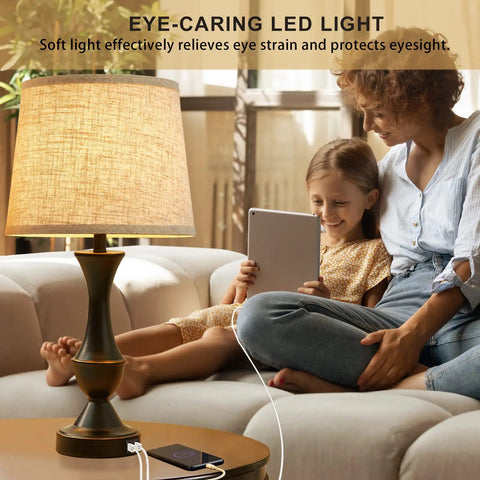 Upgraded 22 Inch Touch Table Lamps Set Of 2 With USB C And USB A Ports Dimmable Nightstand Lamps For Bedroom Living Room Office Black Base With Beige Lampshades Bulbs Included on a table with mother and daughter using device.