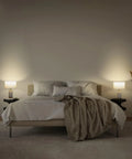 Bedroom scene with two Arden LED Table Lamp With USB Port on nightstands, creating ambient vibe with marble finish and stylish lampshade.