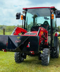 Beefy Stump Bucket For Tractors 32 To 60 HP Front End Loader Attachment on red compact tractor in field