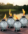 Four Pack Glass Table Torches With Citronella For Outdoor Patio And Garden on table by lake, crystal gem design, lit flames