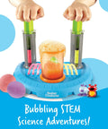 Hands operating Beaker Creatures Liquid Reactor Super Lab STEM Toy Kit with bubbling center and hydroplungers for experiments.