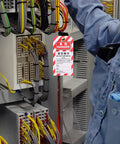 Technician applying 5 Piece Lockout Tag Kit for Equipment Repair PVC Safety Warning Tags to electrical panel