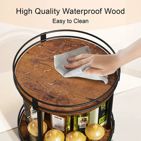 Hand wiping Rotating Spice Rack Two Tier Lazy Susan Organizer For Kitchen Countertop, brown wood surface, with spices below.