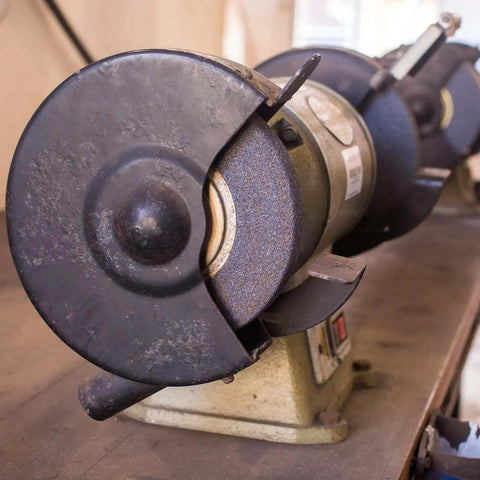 Close-up of a two-pack bench grinder with installed arbor washer flange set, pro grade carbon steel, visible grinding wheels