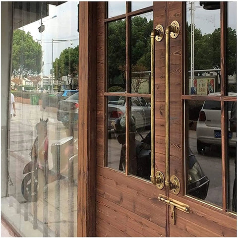 Street Tough Industrial Pipe Railing Kit With Galvanized Steel And Antique Brass Finish Solid Wrought Iron Style stair handrail on wooden door.