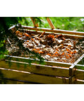 Green Label Larch Wood Composter With Plug In System, Square 79 Cm, visible composting leaves and twigs in wooden bin