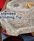 Close-up of No Fuss Manual Stone Grain Mill with hand crank, featuring granite grinding stone and beans, for dry and wet use.