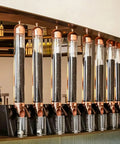 Wall Mounted Coffee Bean Dispenser With Slick Glass Tube And Rugged Steel Base, features multiple glass tubes for easy access.