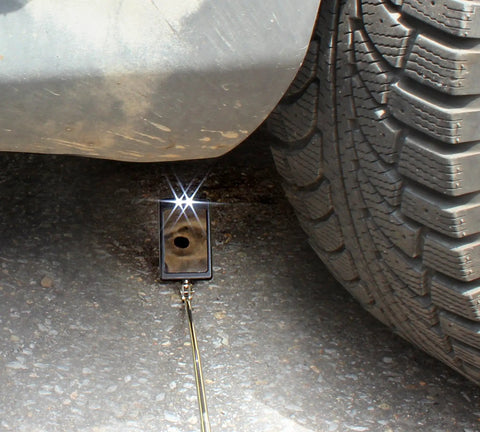Telescoping Swiveling Inspection Mirror Tool With Twin White LED Lights in use under vehicle for inspection