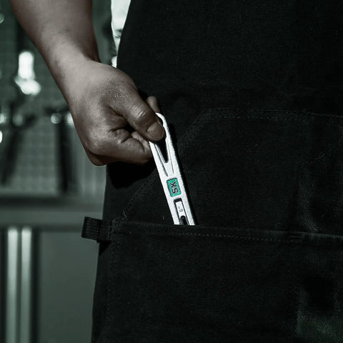 Person placing 6 inch wrench from Three Piece Adjustable Wrench Set 6 Inch 8 Inch 10 Inch Chrome Vanadium Steel SAE And Metric Scales into pocket