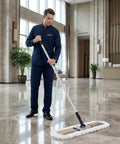 Heavy Duty 24 Inch Commercial Dust Mop Featuring Plush Absorbent Microfiber Pad For Quick Wet Or Dry Floor Cleaning in use by a person.