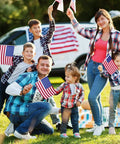 Family with All American Flags On Sticks 12 Pack 8x12 Inch Wood Stick Flags celebrating outdoors