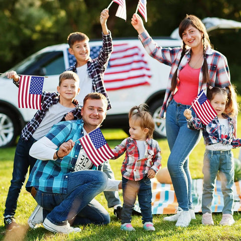Family with All American Flags On Sticks 12 Pack 8x12 Inch Wood Stick Flags celebrating outdoors