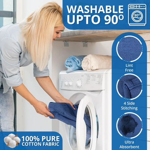 Woman loading Blue Huck Towels Pack Of 12 Cleaning Rags 100 Percent Cotton Ultra Absorbent Lint Free Towels into washing machine