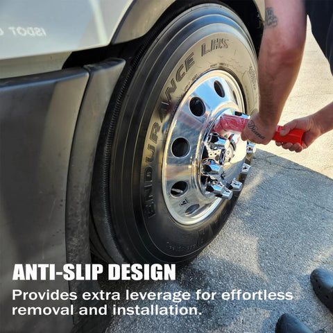 Side view of a red 33 mm lug nut cover remover socket being used on a chrome semi-truck wheel with a black tire