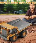 Child playing with Remote Control Dump Truck For Kids Nine Channel RC Construction Vehicle With Metal Dump Bed outdoors