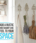 Distressed White Cast Iron Wall Hooks Set Of Three Dang Sturdy Farmhouse Coat Rack holding herbs and a kitchen towel.