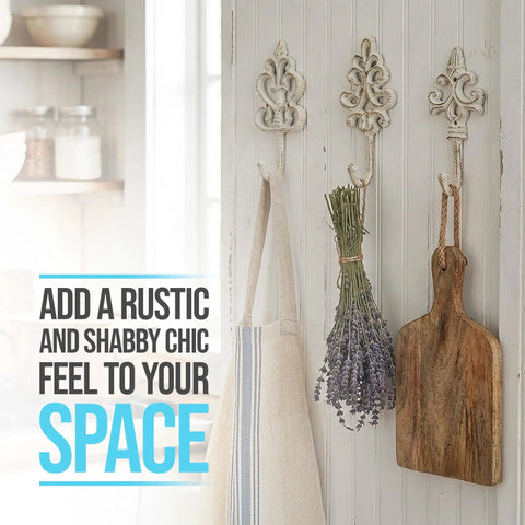 Distressed White Cast Iron Wall Hooks Set Of Three Dang Sturdy Farmhouse Coat Rack holding herbs and a kitchen towel.