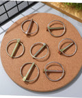 Heavy Duty Lynch Pin Assortment Kit, 10-Piece Set, 3/16 Inch Locking Clips For Farm Tractors, Trailers, And Lawn Mowers, Smooth Edges For Safe Handling, Secure Lock, Prevents Accidental Disengagement, Durable Steel Pins displayed on cork board