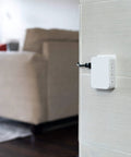 Side view of Six Outlet Surge Protector Wall Tap Extender With Side Access, 1500 Joules, 2 Pack, mounted on wall in living room