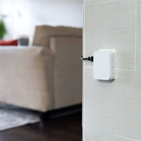 Side view of Six Outlet Surge Protector Wall Tap Extender With Side Access, 1500 Joules, 2 Pack, mounted on wall in living room