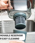 Person removing filter from No Fuss 10 Cup Gravity Water Filter Pitcher For Refrigerator With 150 Gallon Filter Easy Pour Refill Space Saving Design In Black And Bamboo Finish