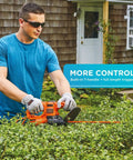 Man using Powerful 3.0 Amp Electric Hedge Trimmer With 16 Inch Blade Lightweight Compact Corded Yard Tool for trimming shrubs