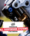 Close-up of bicycle shock absorber demonstrating compatibility with all suspension systems, promoting 5Wt Suspension Shock Oil use.