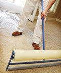 Applying Heavy Duty Carpet Shield Film 36 Inch By 500 Feet 2 Mil Tear Resistant Masking Film to carpet with roller applicator