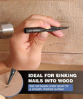Using Cr-V Hardened Nail Punch And Center Punch Set With Knurled Grip to drive nails into wood, showing tool in hand against wooden surface.