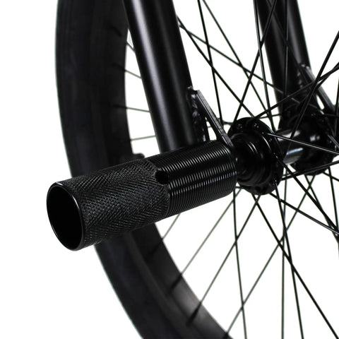 Close-up of peg on BMX Freestyle Bike with Durable Steel Frame in White for stunts; showcases black wheel and axle detail