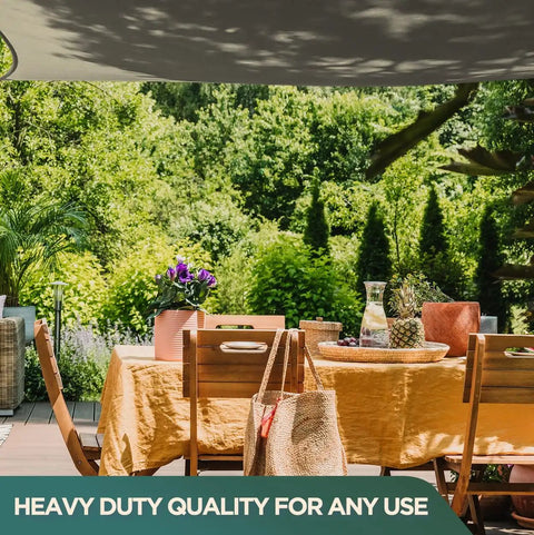 Black waterproof heavy duty silicone coated polyester tarp for awnings, 10x10 feet, in use over outdoor dining area with greenery.