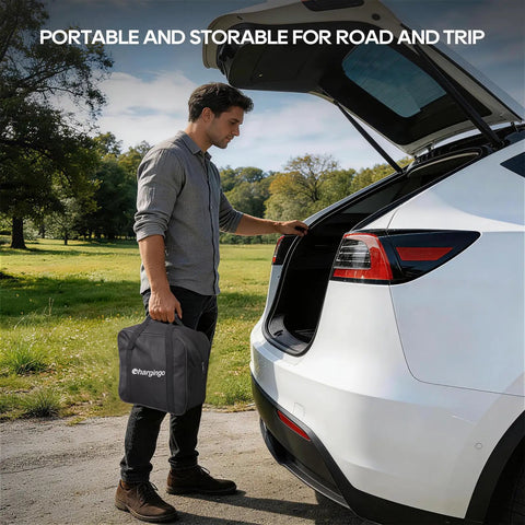 Man holding Portable Level One and Level Two EV Charger for Teslas and Other EVs, next to car trunk, travel bag visible