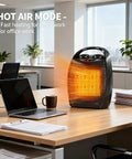 Portable Electric Space Heater That Is 2 In 1 Desk Heater And Fan, shown on office desk heating, with laptop and documents.
