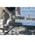 Worker using London Style Brick Trowel With DuraSoft Handle For Brickwork Blockwork And Stonework High Carbon Steel One Piece Forged Pro Grade Blade With Polished Finish Made In USA Size Ten By Four And Five Eighths Inch Masonry Tool to apply mortar to bricks